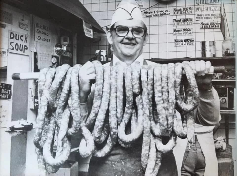 Fred Jaworski, The Kielbasa King, draped in fresh homemade Polish kielbasa at the original Jaworski Meats