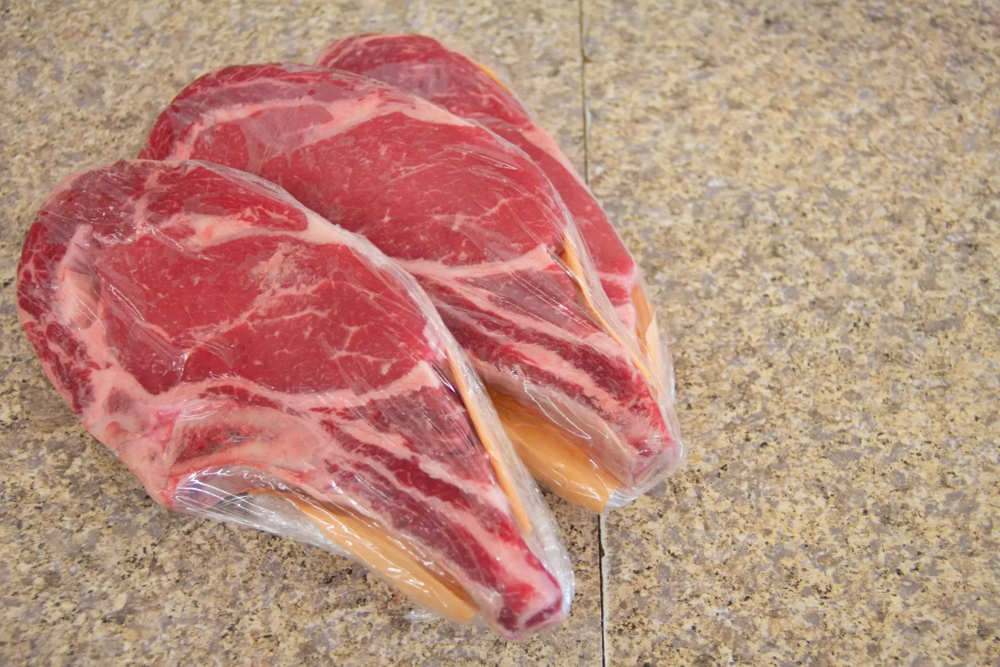 Two thick ribeye steaks wrapped in butcher paper at Jaworski Meats, cut to order since 1935