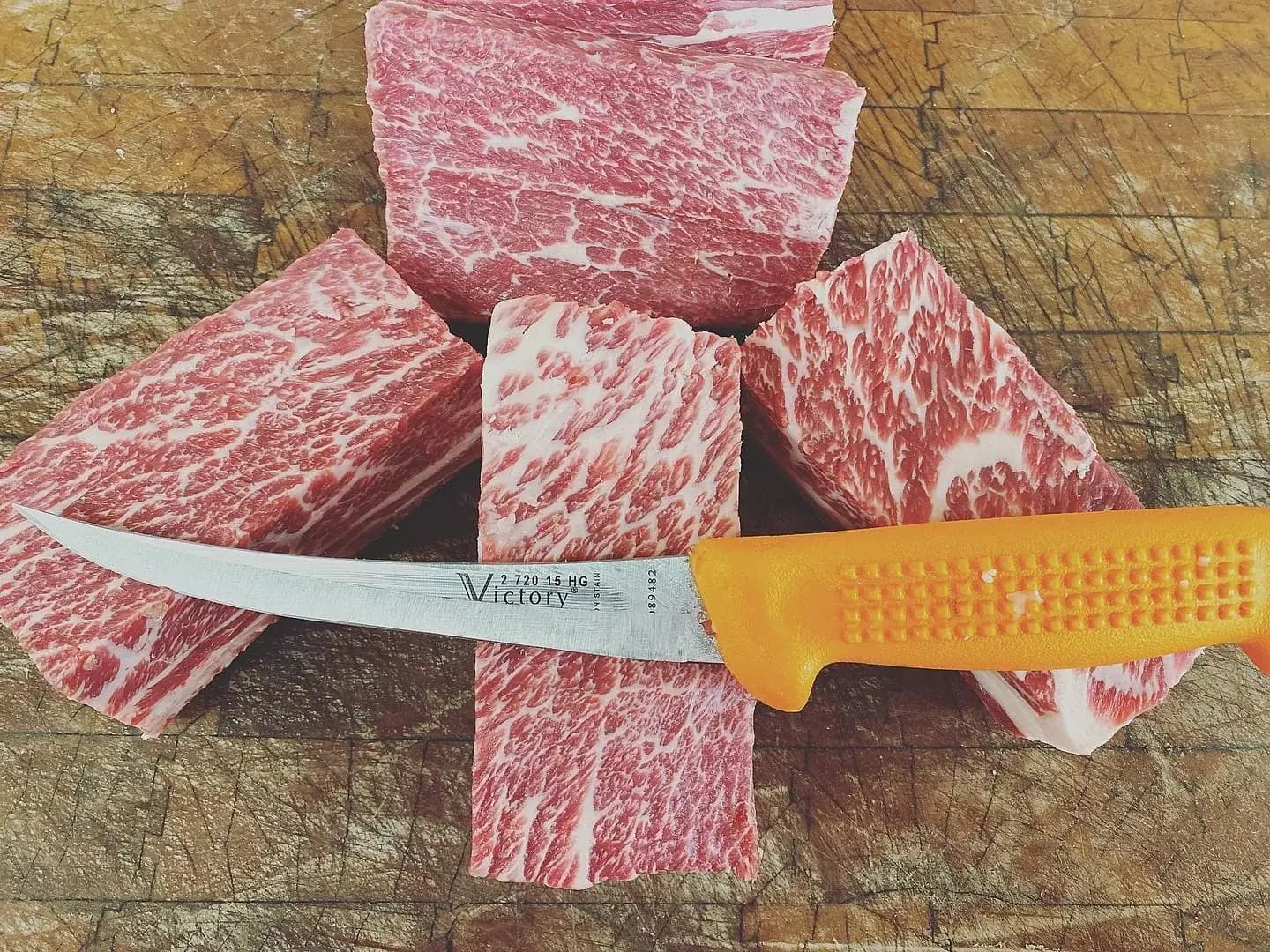 Fresh wagyu beef cubes on a butcher block at Jaworski Meats